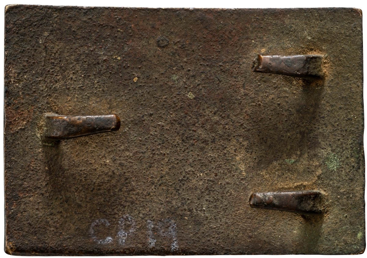 Reverse of a cast belt plate showing three period hooks bent down against the back